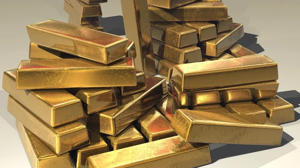Pile of gold bars stacked on a table